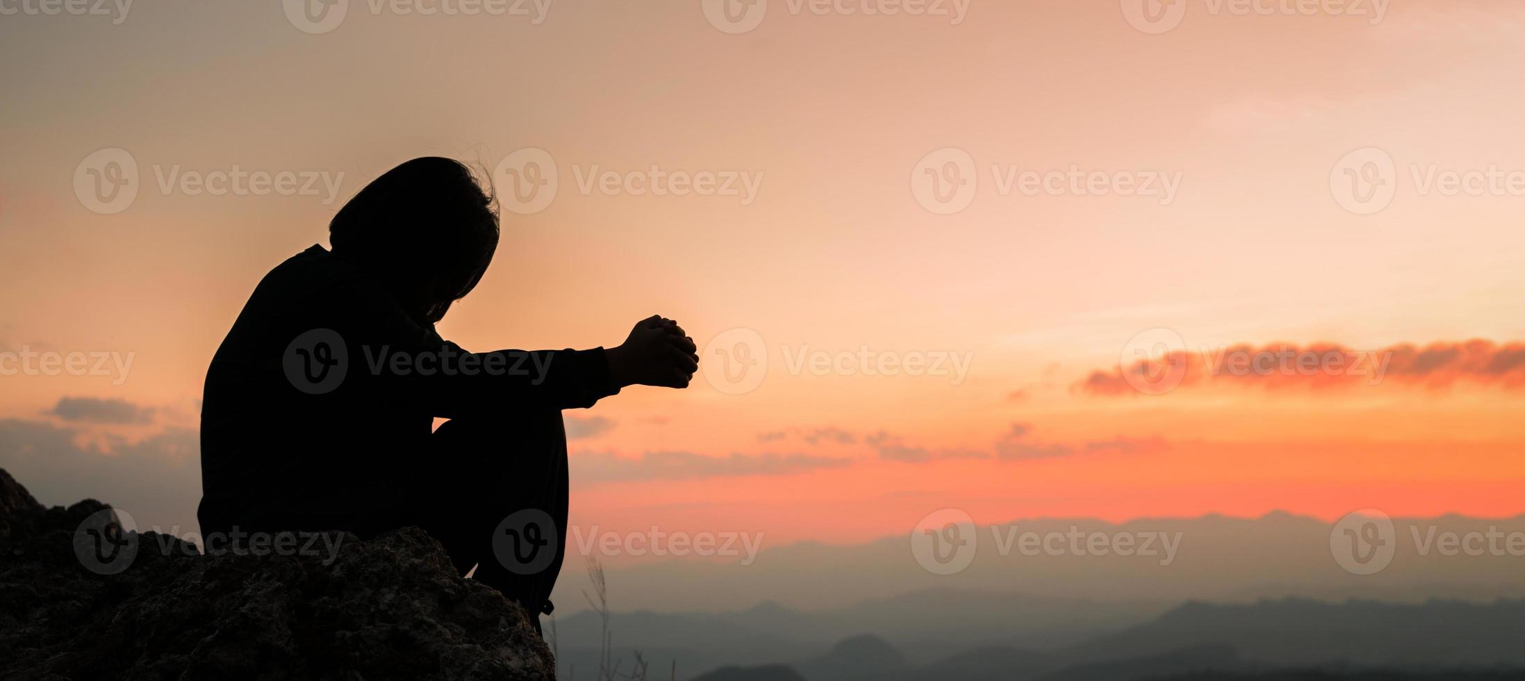 Banner of Faith christianity with christian worship concept. Spiritual prayer hands over sun shine with blurred beautiful sunset background. Woman praying to god with hopeful blessing against sunset. photo