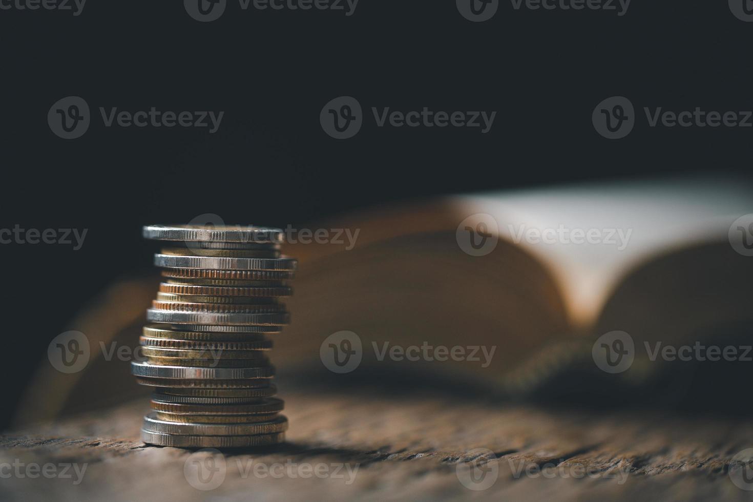 One tenth or tithe is basis on which Bible teaches us to give one tenth of first fruit to God. coins with Holy Bible. Biblical concept of Christian offering, generosity, and giving tithes in church. photo