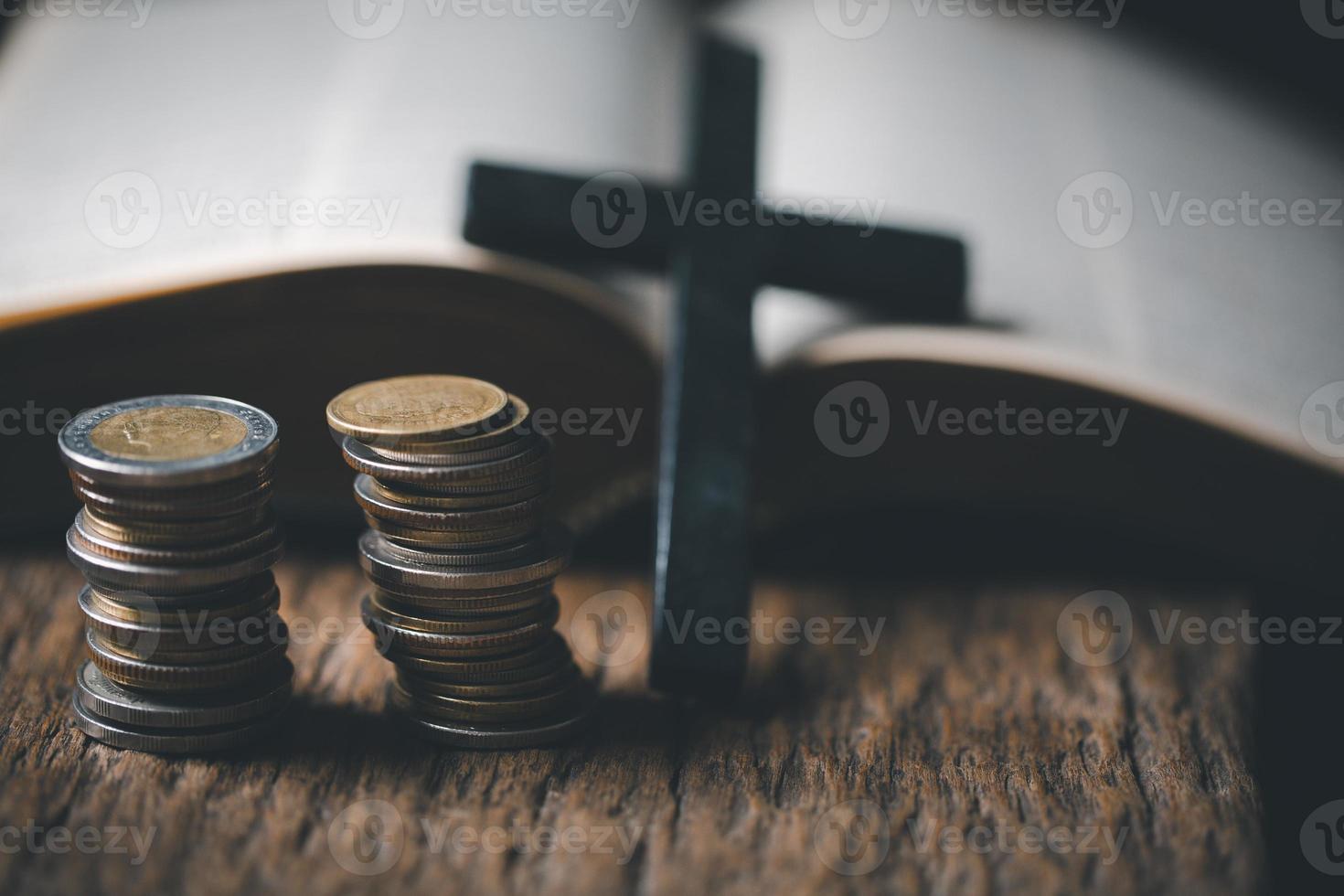 One tenth or tithe is basis on which Bible teaches us to give one tenth of first fruit to God. coins with Holy Bible. Biblical concept of Christian offering, generosity, and giving tithes in church. photo