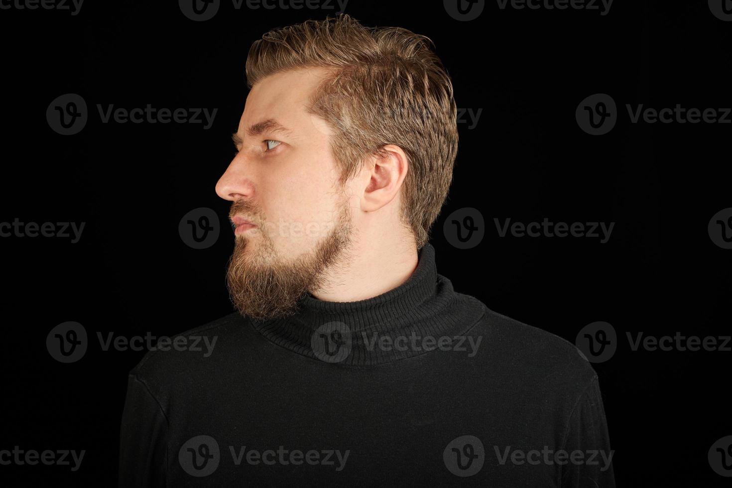 Cute bearded man, half-face portrait, black background photo