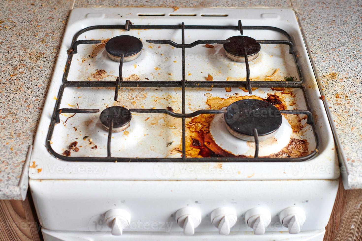 Dirty stove with food leftovers photo