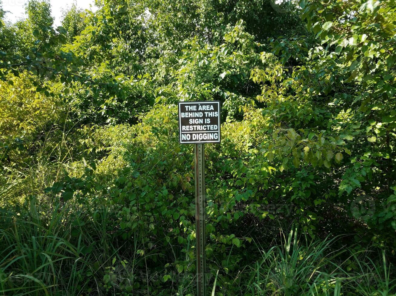 area behind this sign is restricted no digging photo