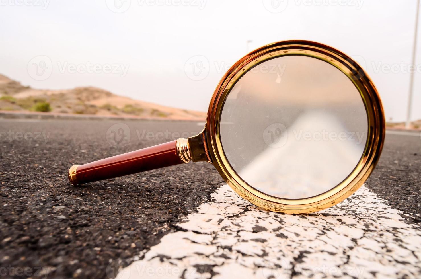 Magnifying glass on the road photo