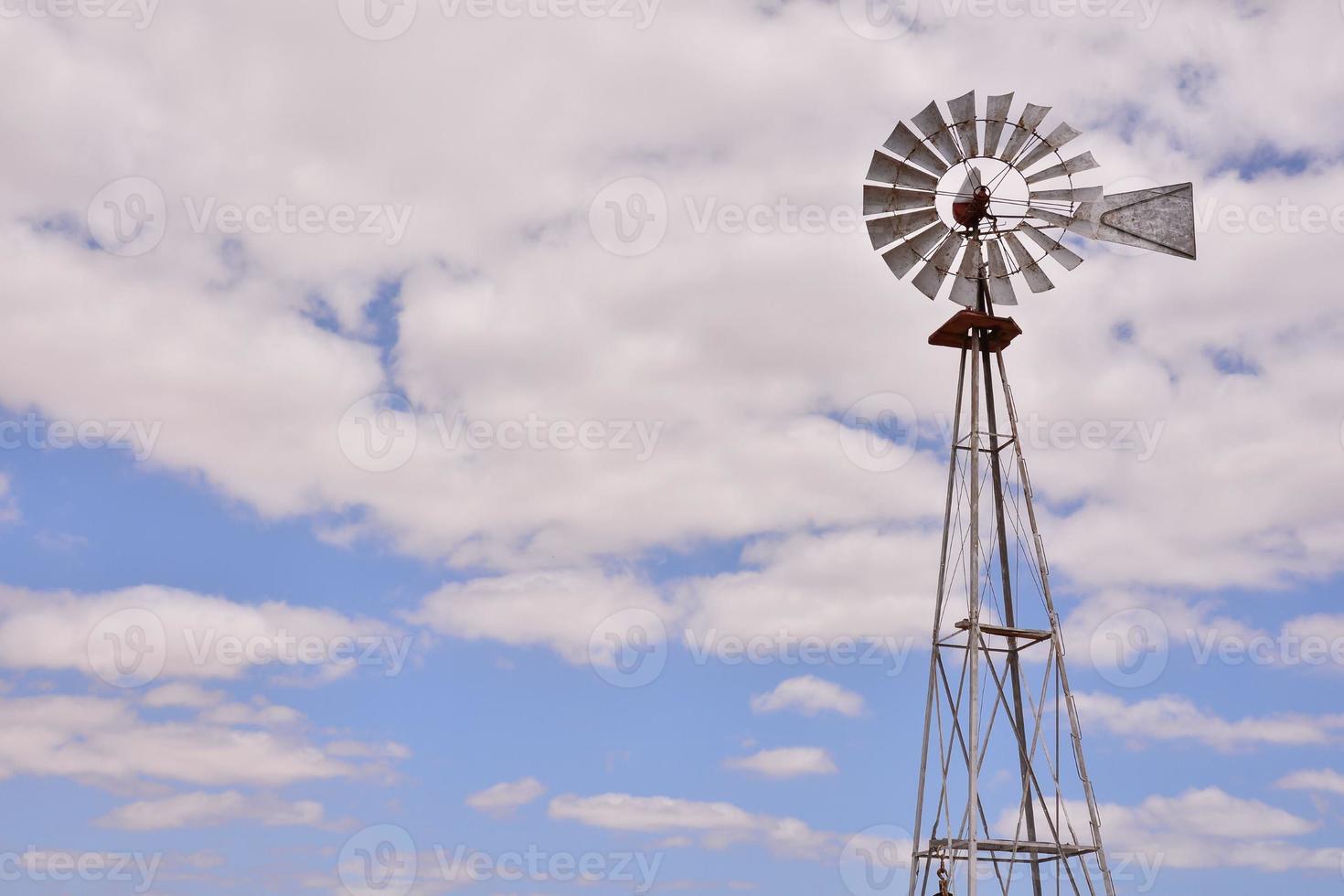 Traditional windmill under clear blue sky photo