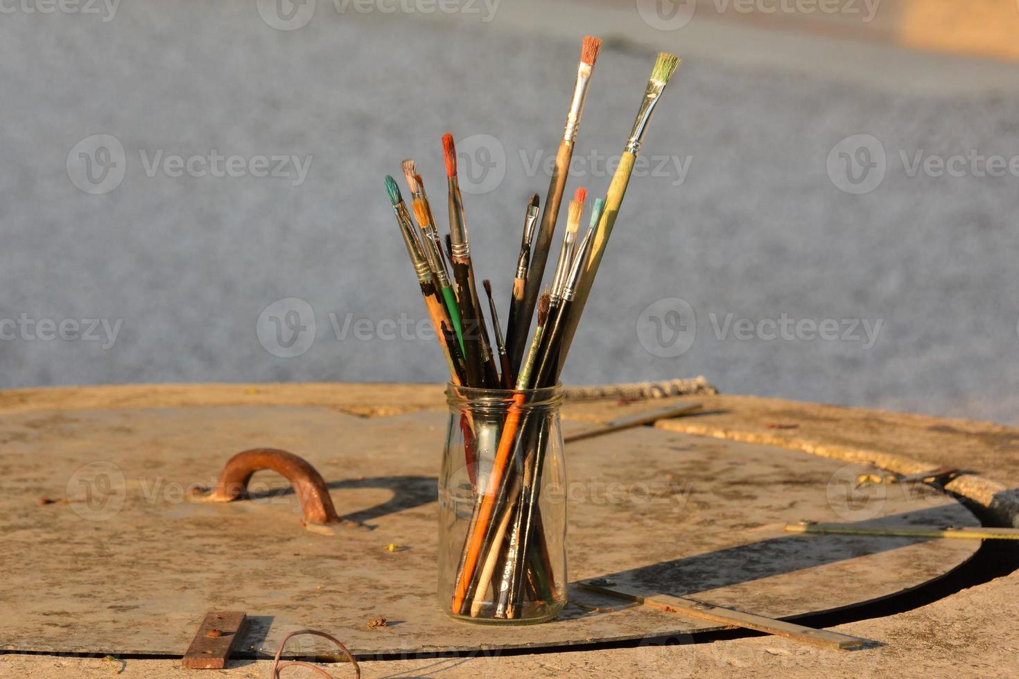 Cup with paint brushes photo