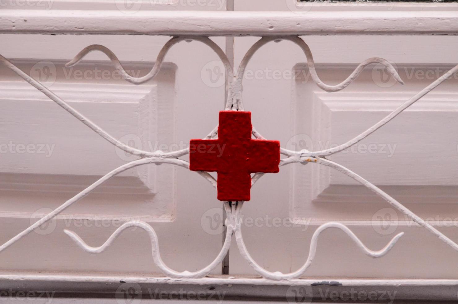 Red cross on metal detail photo