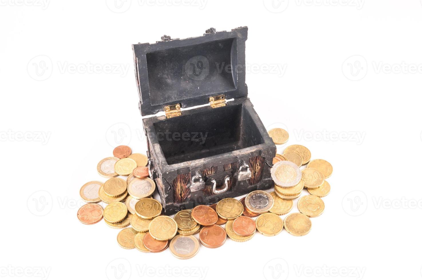 Miniature treasure trunk on coins photo