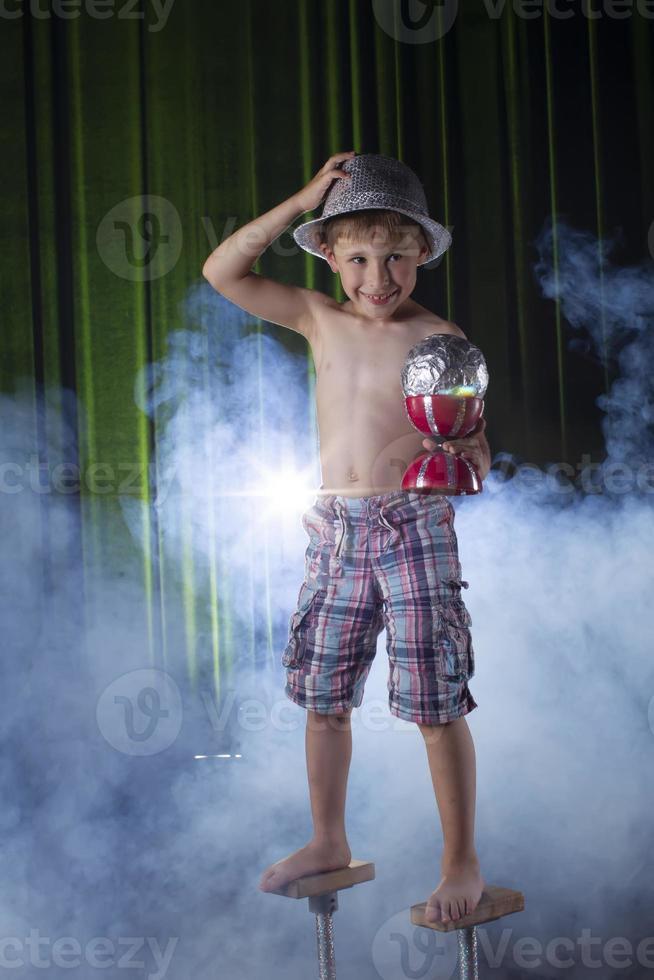 Little boy learns to juggle. Child of the circus. photo