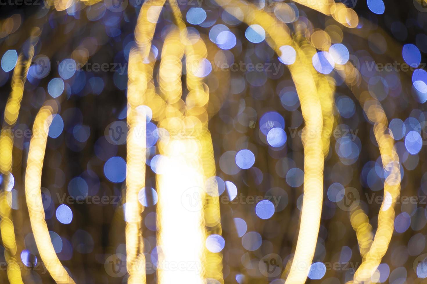 Spots of blue and gold bokeh on a dark background. photo