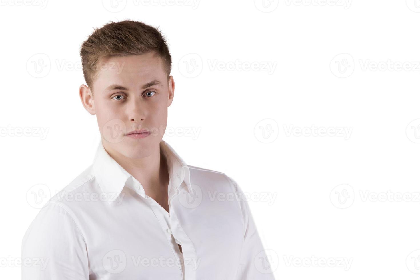 Portrait of a young man in a white shirt on an isolated background. photo