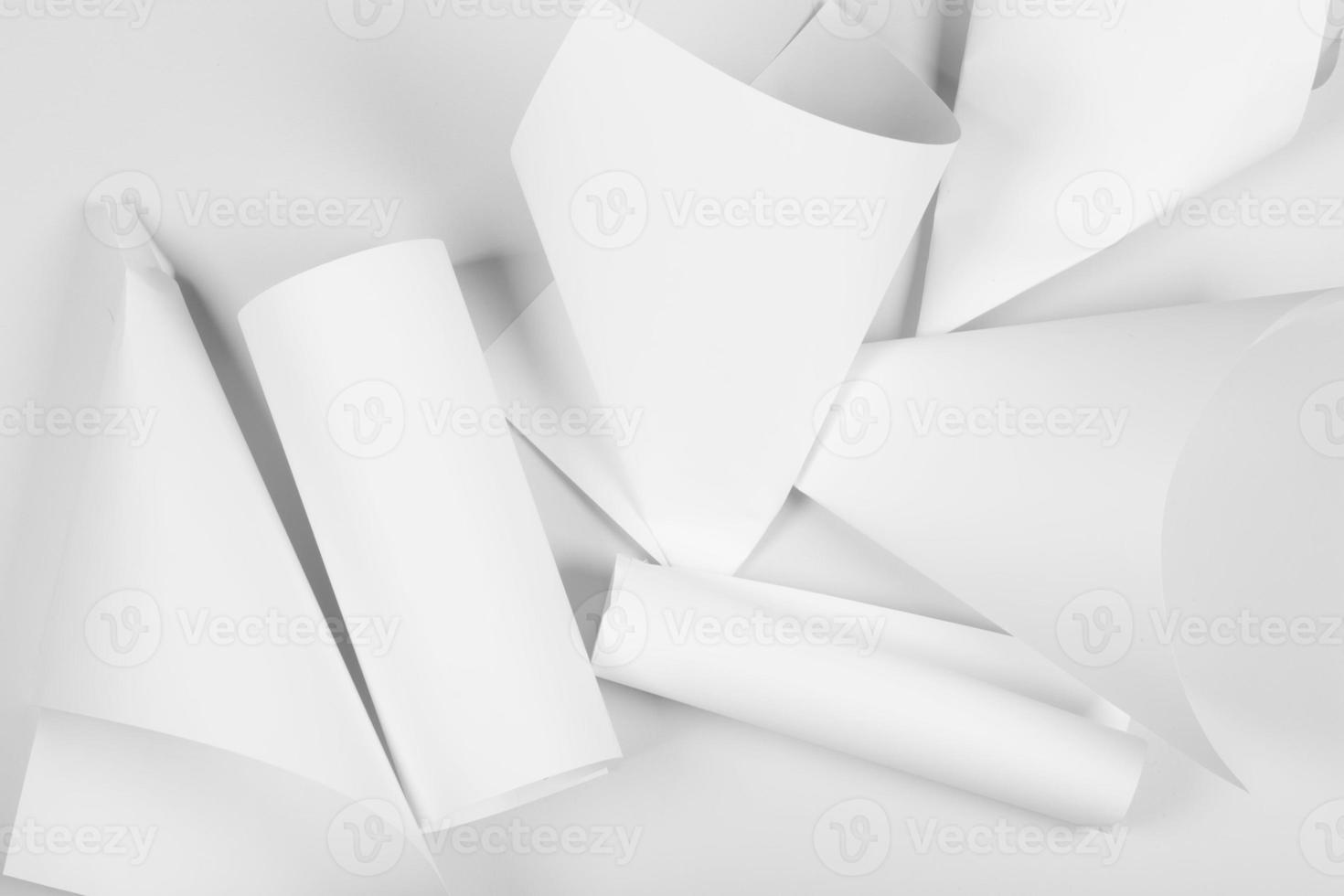 White sheets of office paper are twisted and scattered. Paper white