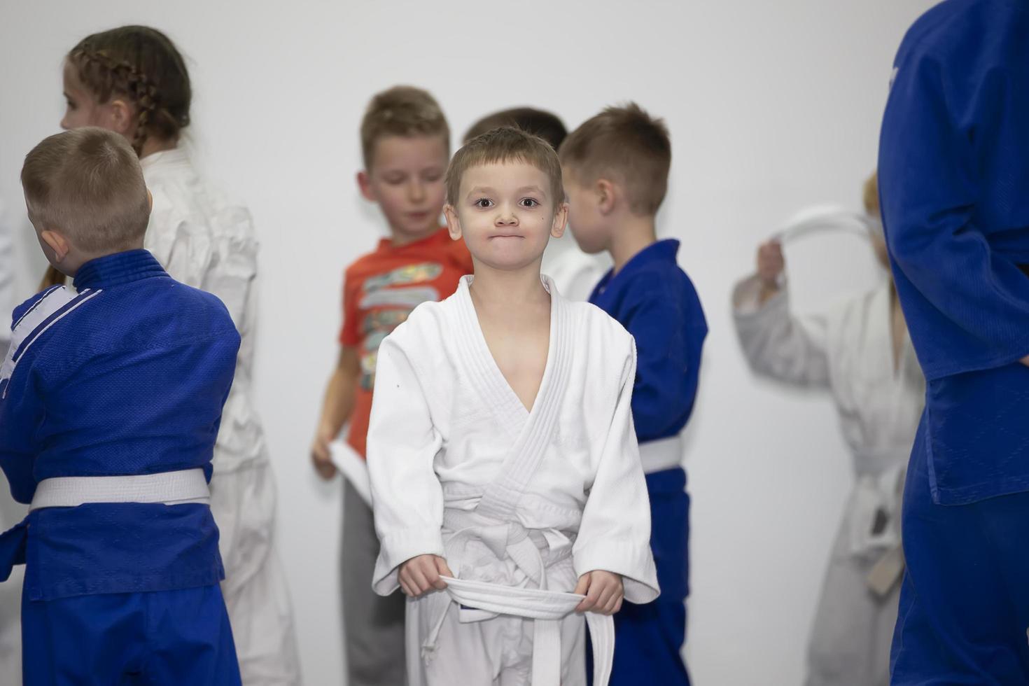 Belarus, city of Gomel, December 15, 2021. Judo school for children. Little boy in kimano in training. photo
