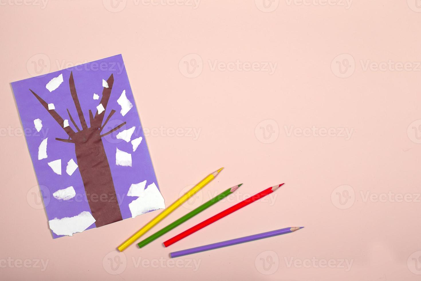 Paper crafts for children. Application of children's creativity. Kindergarten and craft school. On a pink background, a tree made of colored paper. photo