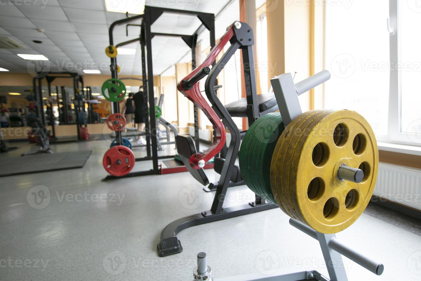 Sports trainer with metal weights for the barbell in the gym. photo