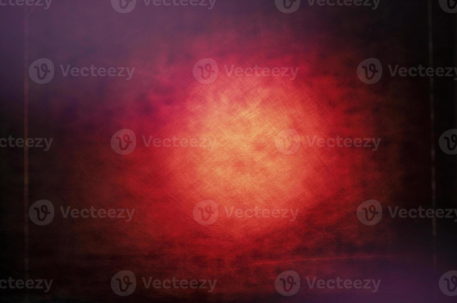 Red grunge background with a dark vignette and a light spot in the middle. photo