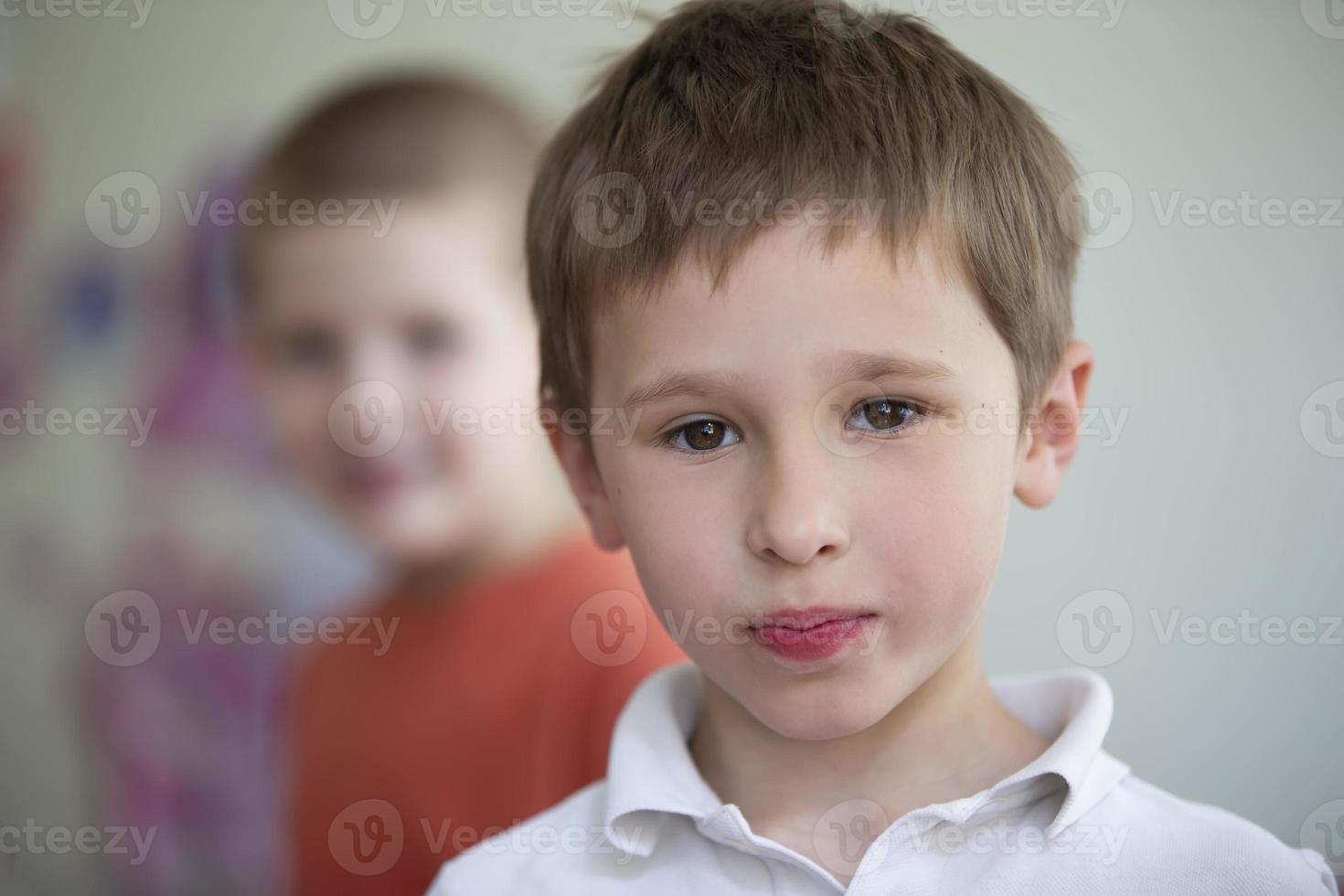 The face of a five-year-old boy with brown eyes. The little boy looks into the camera. photo