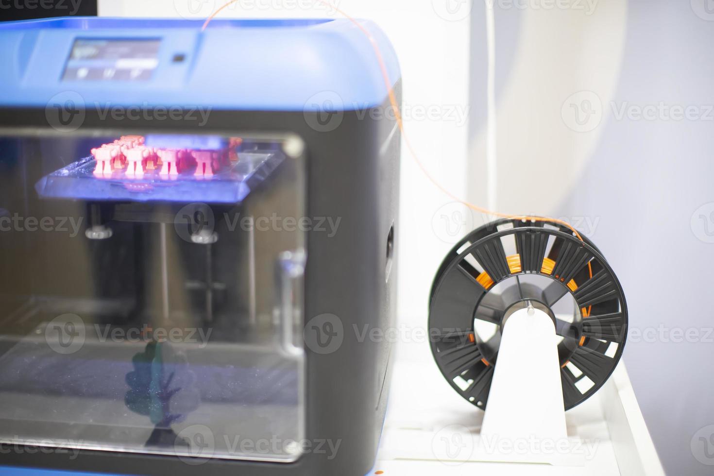 Large 3D printer with a spool of wire. photo