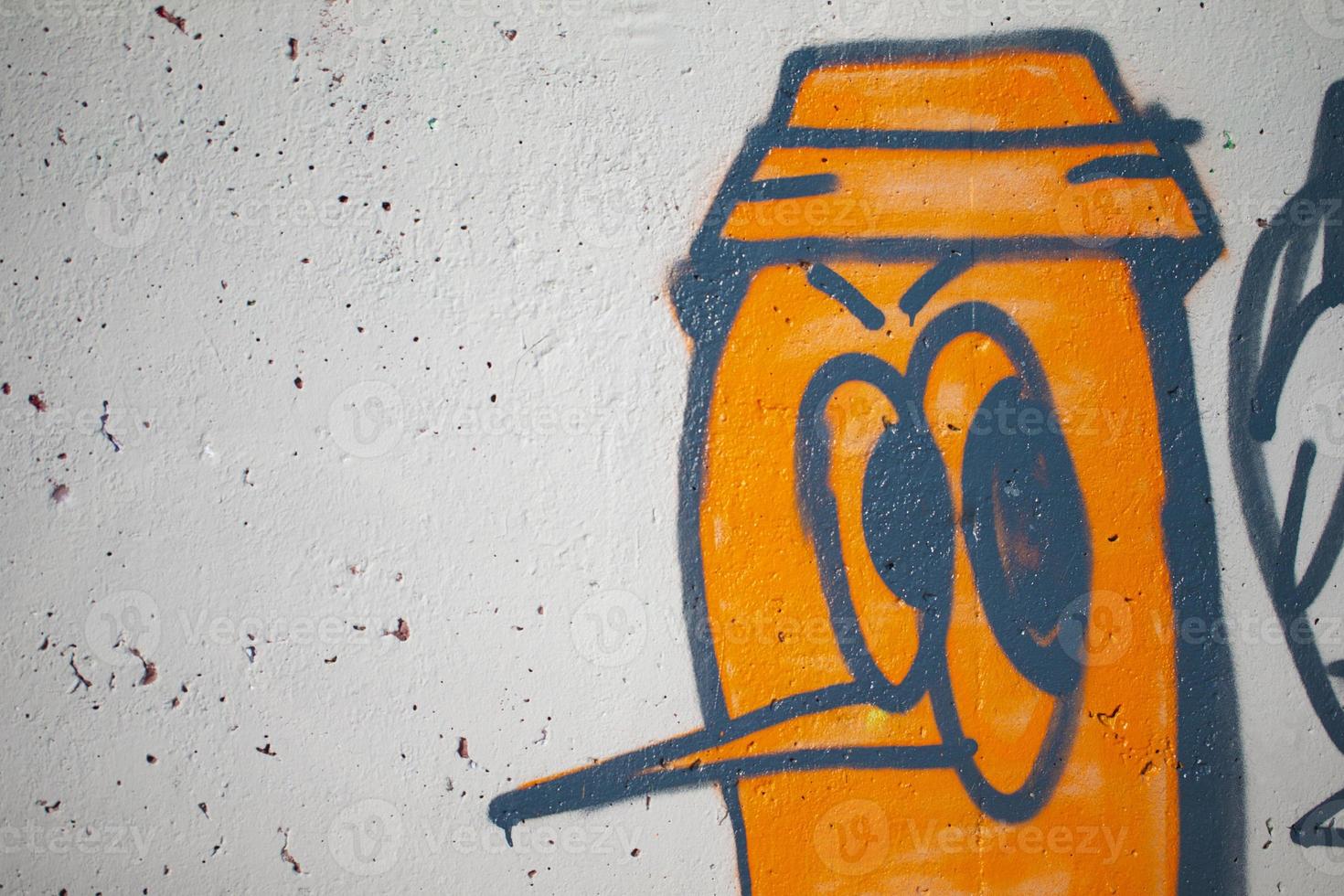 Fragments of a drawn caricatured person. The wall is painted with spray paint. Concrete graffiti wall texture. photo