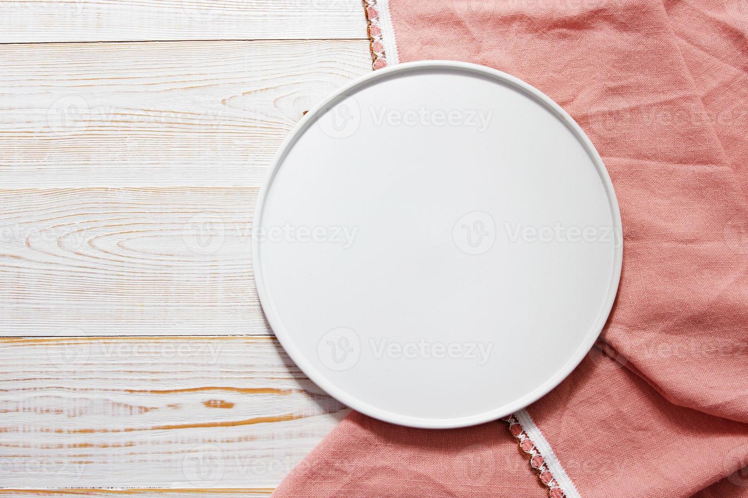 empty round tray and tablecloth on wooden background top view photo