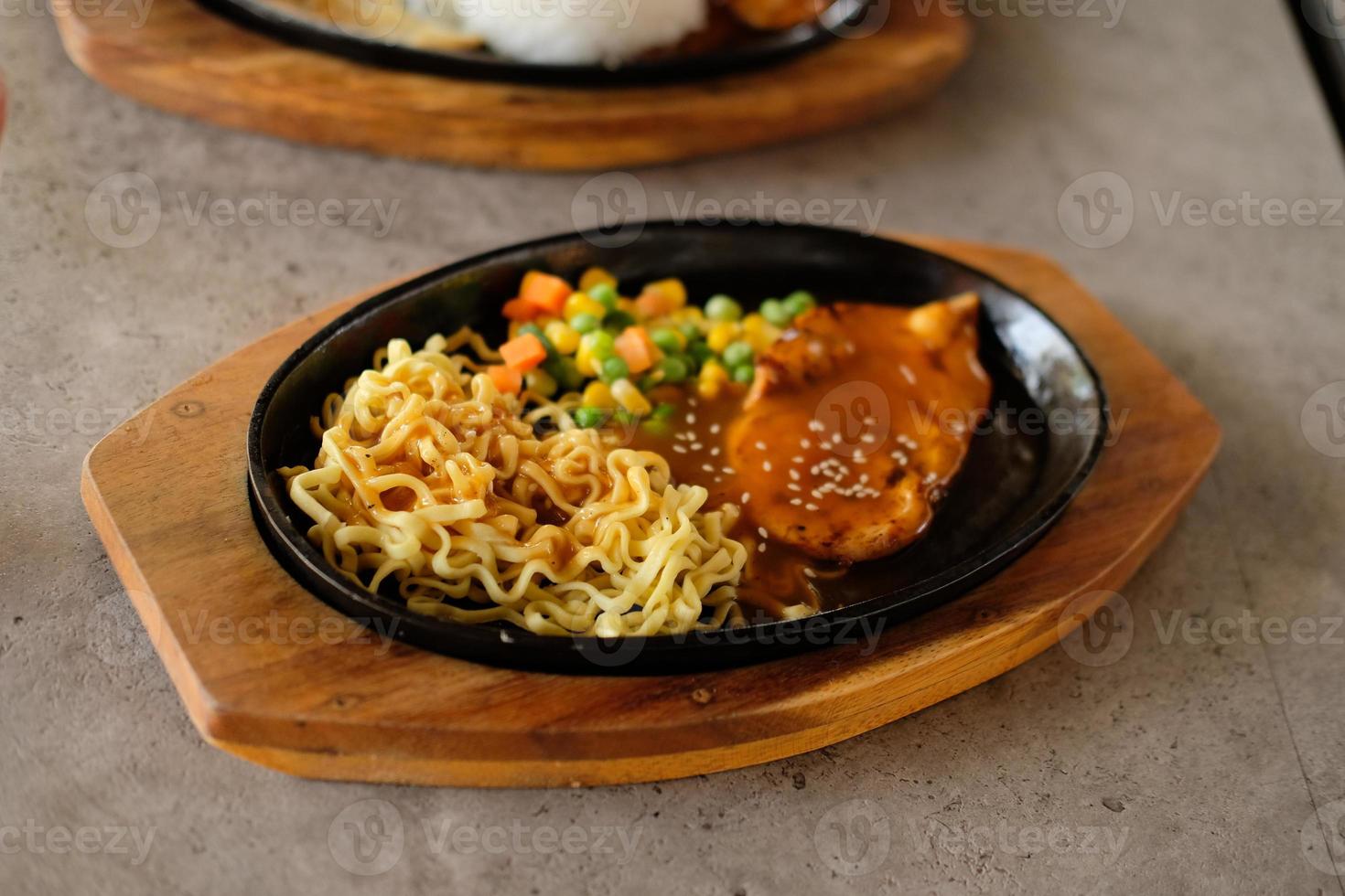 Close-up of a bowl of soba noodles with sliced roast beef steak. Asian cuisine photo