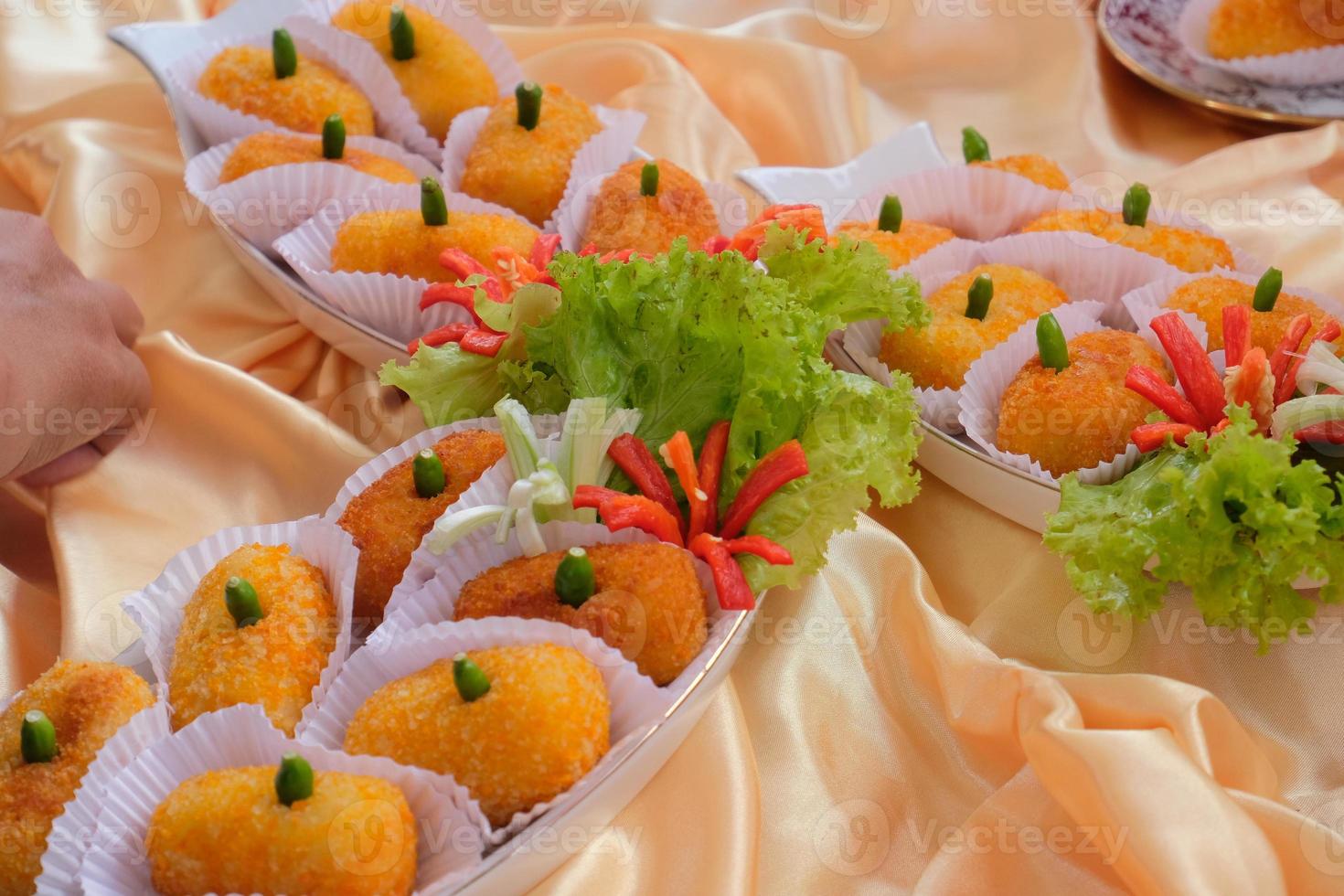 Kroket kentang is a traditional snack from Indonesia. served in wooden plate with green chilli. Delicious Indonesian Traditional Kroket Kentang with chilli photo