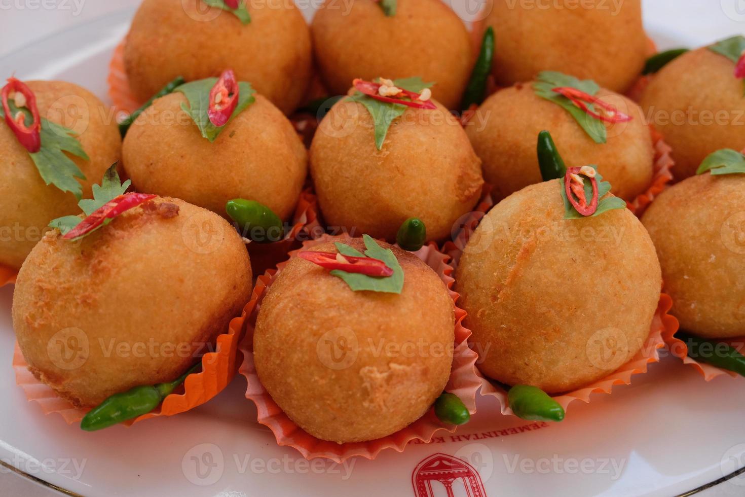 Kroket kentang is a traditional snack from Indonesia. served in wooden plate with green chilli. Delicious Indonesian Traditional Kroket Kentang with chilli photo