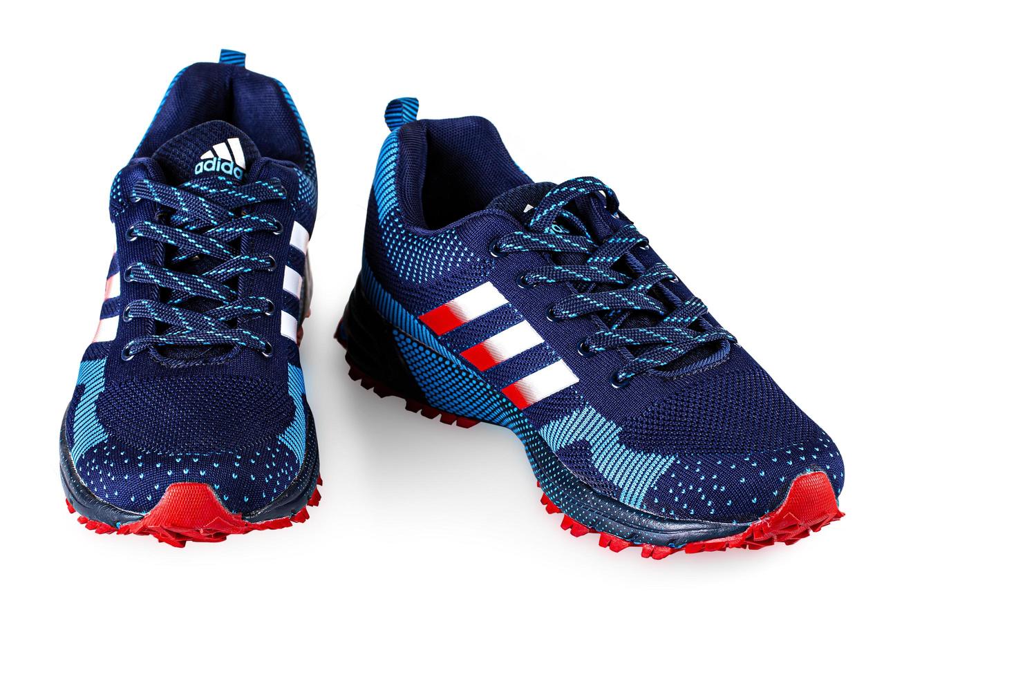 KAMCHATKA, RUSSIA - JANUARY 16, 2023- Blue Adidas Running Sneakers. Adidas, Germany company. Isolated on white. photo