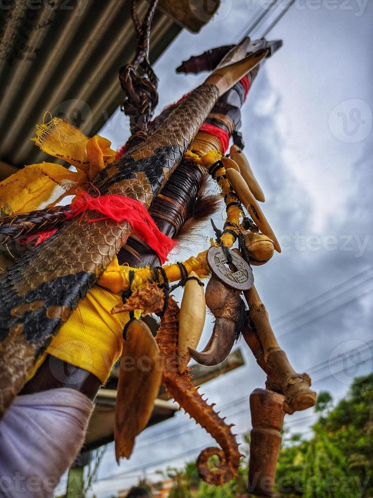 a typical Kalimantan mandau sword, with a decoration called penyang which is taken from various kinds such as bear hooves, sea shells and pieces of deer antlers photo