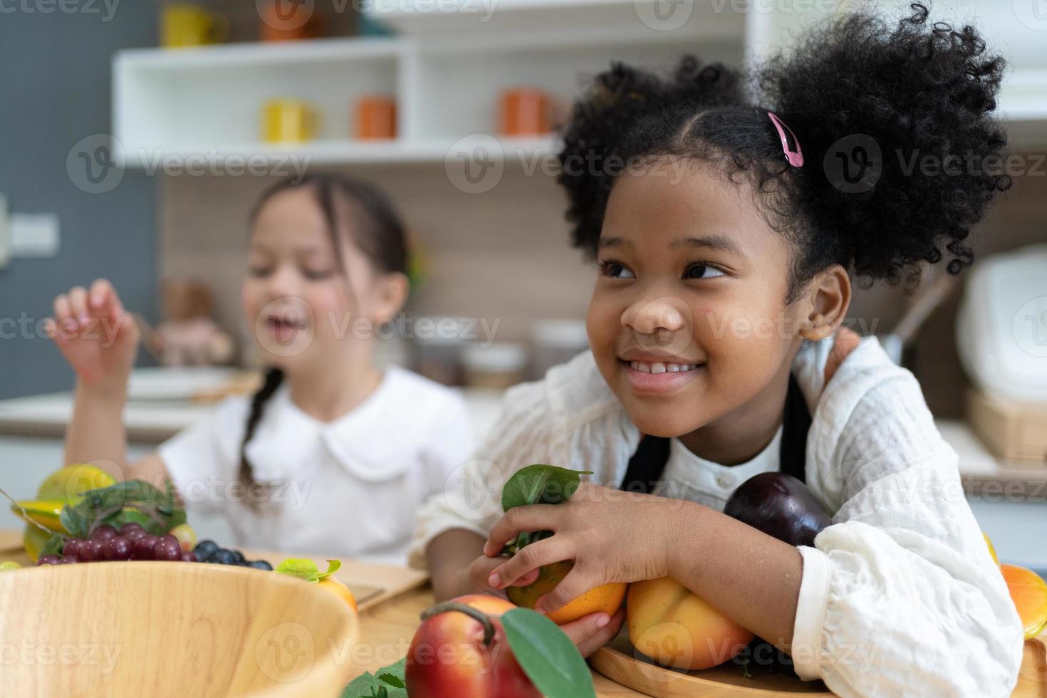 The child is playing fruits. children lying on toy kitchen cooking. Kids Educational, creative games. photo