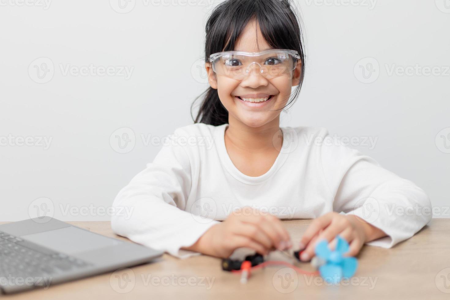 Asia students learn at home in coding robot cars and electronic board cables in STEM, STEAM, mathematics engineering science technology computer code in robotics for kids concept. photo
