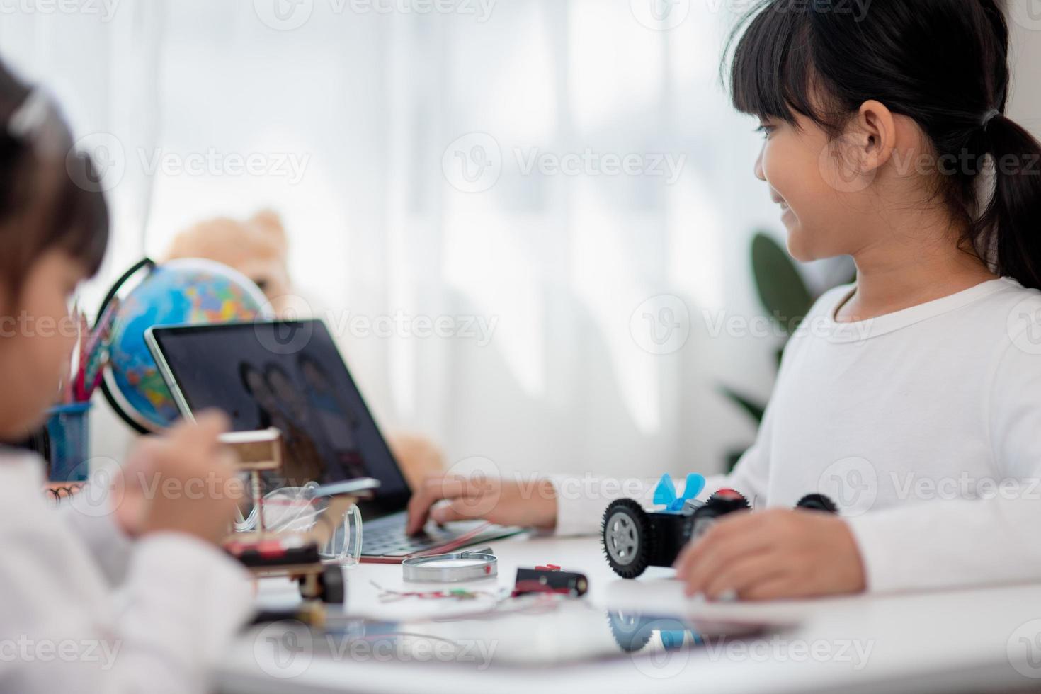Asia students learn at home in coding robot cars and electronic board cables in STEM, STEAM, mathematics engineering science technology computer code in robotics for kids concept. photo
