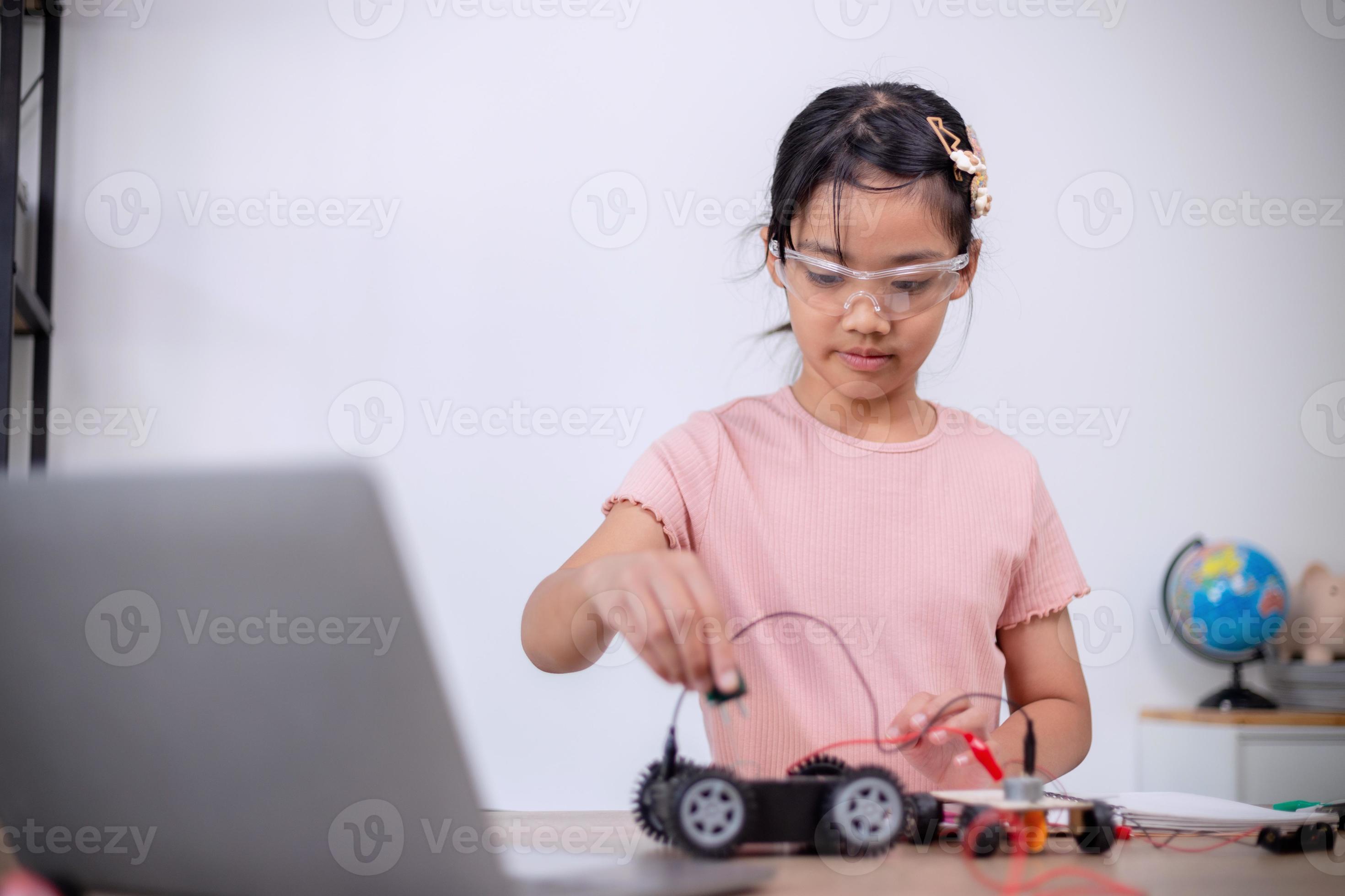 Asian students learn at home by coding robot cars and electronic board ...