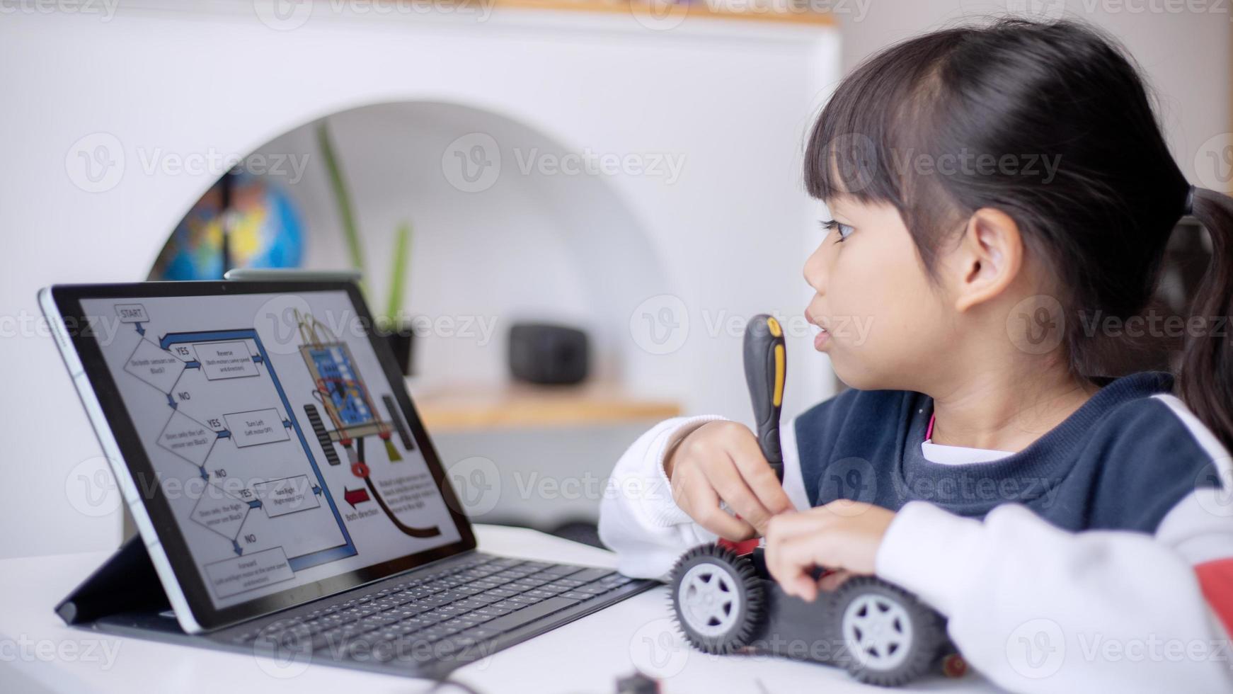 Asia students learn at home in coding robot cars and electronic board cables in STEM, STEAM, mathematics engineering science technology computer code in robotics for kids concept photo