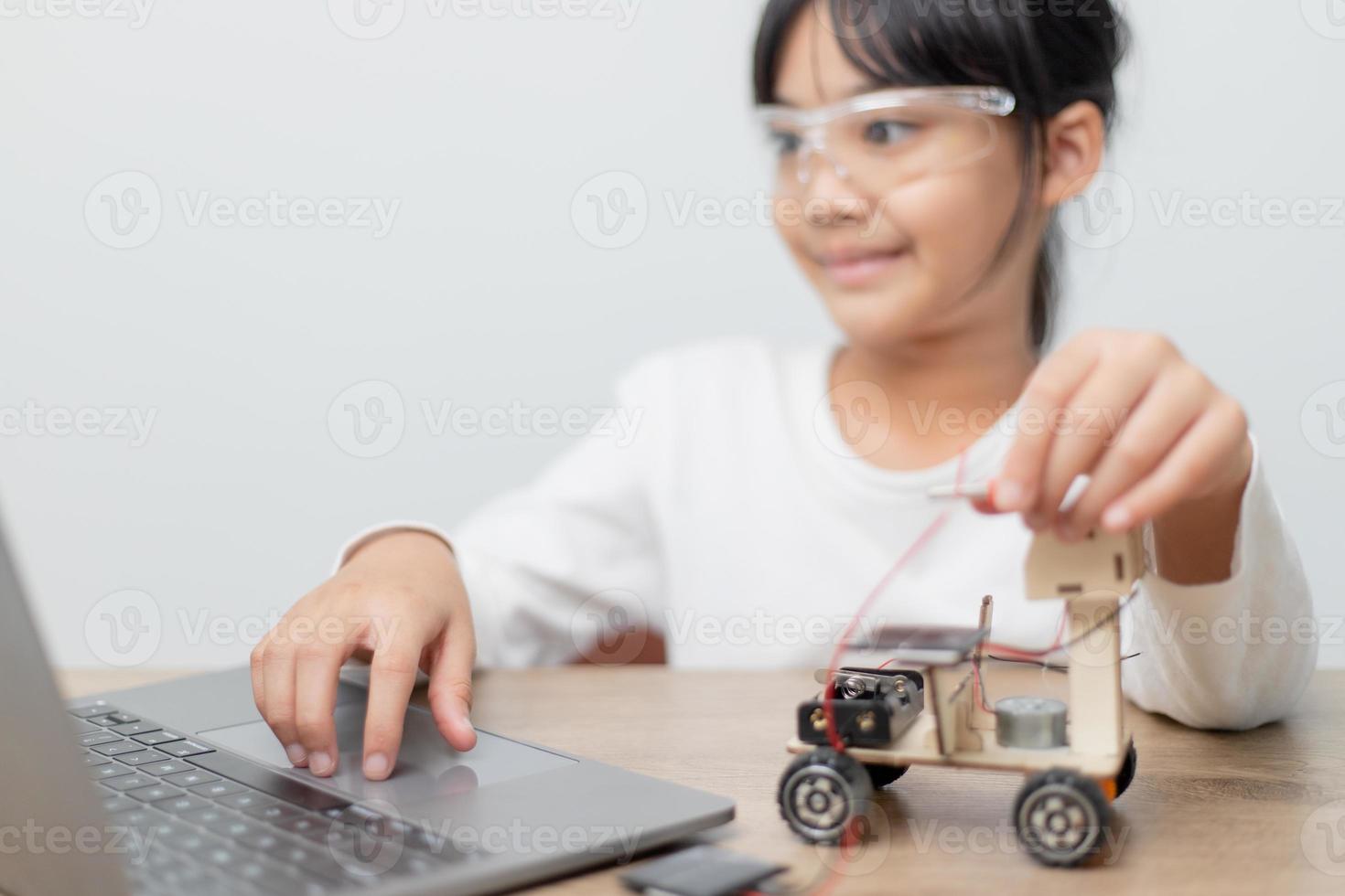 Asia students learn at home in coding robot cars and electronic board cables in STEM, STEAM, mathematics engineering science technology computer code in robotics for kids concept. photo