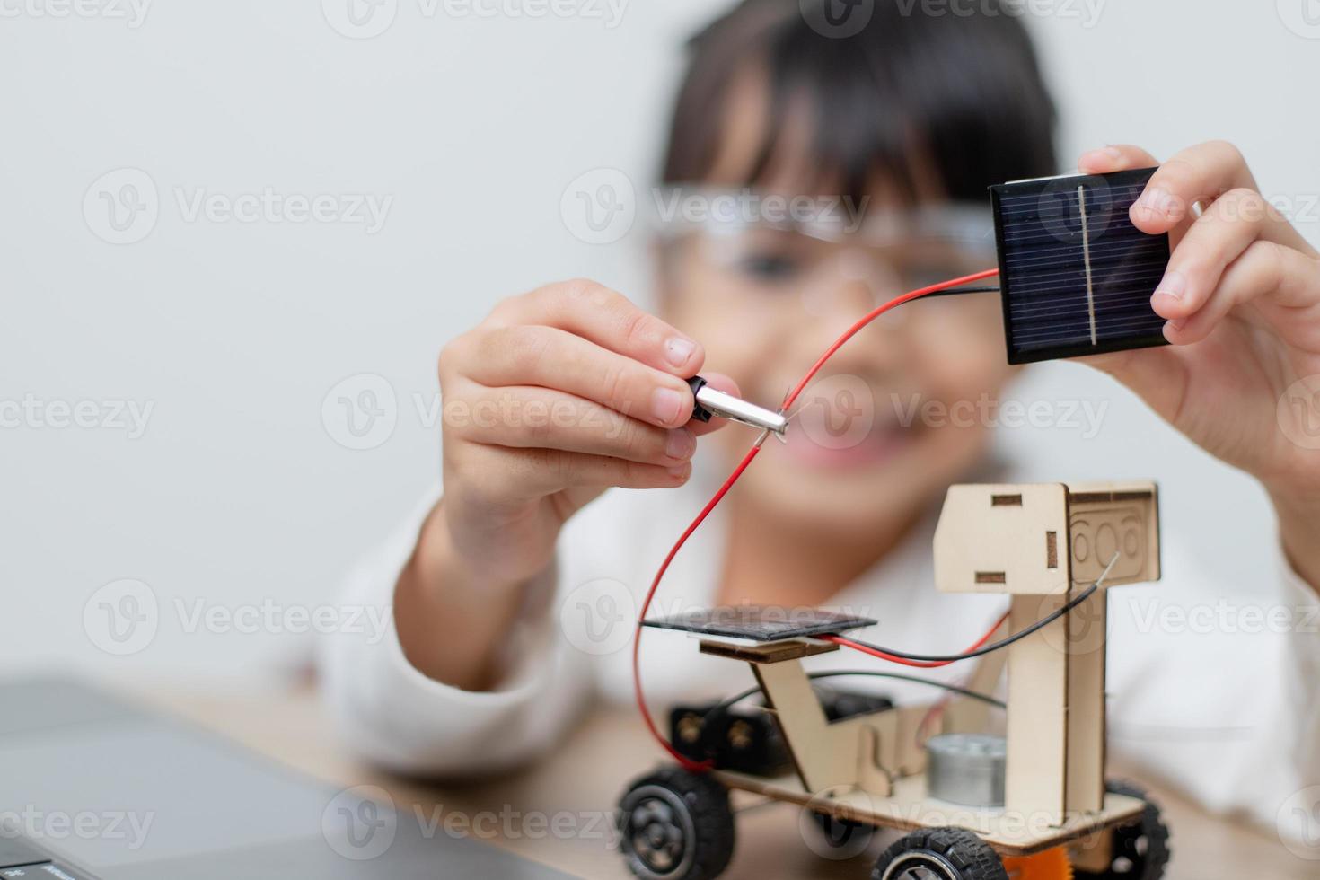 Asia students learn at home in coding robot cars and electronic board cables in STEM, STEAM, mathematics engineering science technology computer code in robotics for kids concept. photo