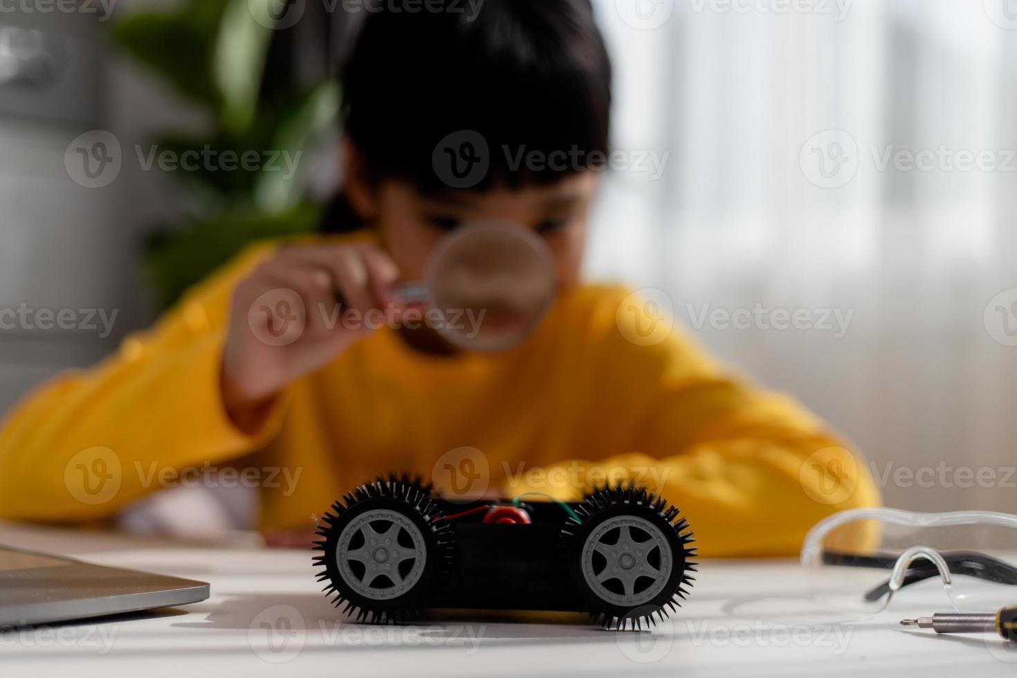 Asia students learn at home in coding robot cars and electronic board cables in STEM, STEAM, mathematics engineering science technology computer code in robotics for kids concept. photo