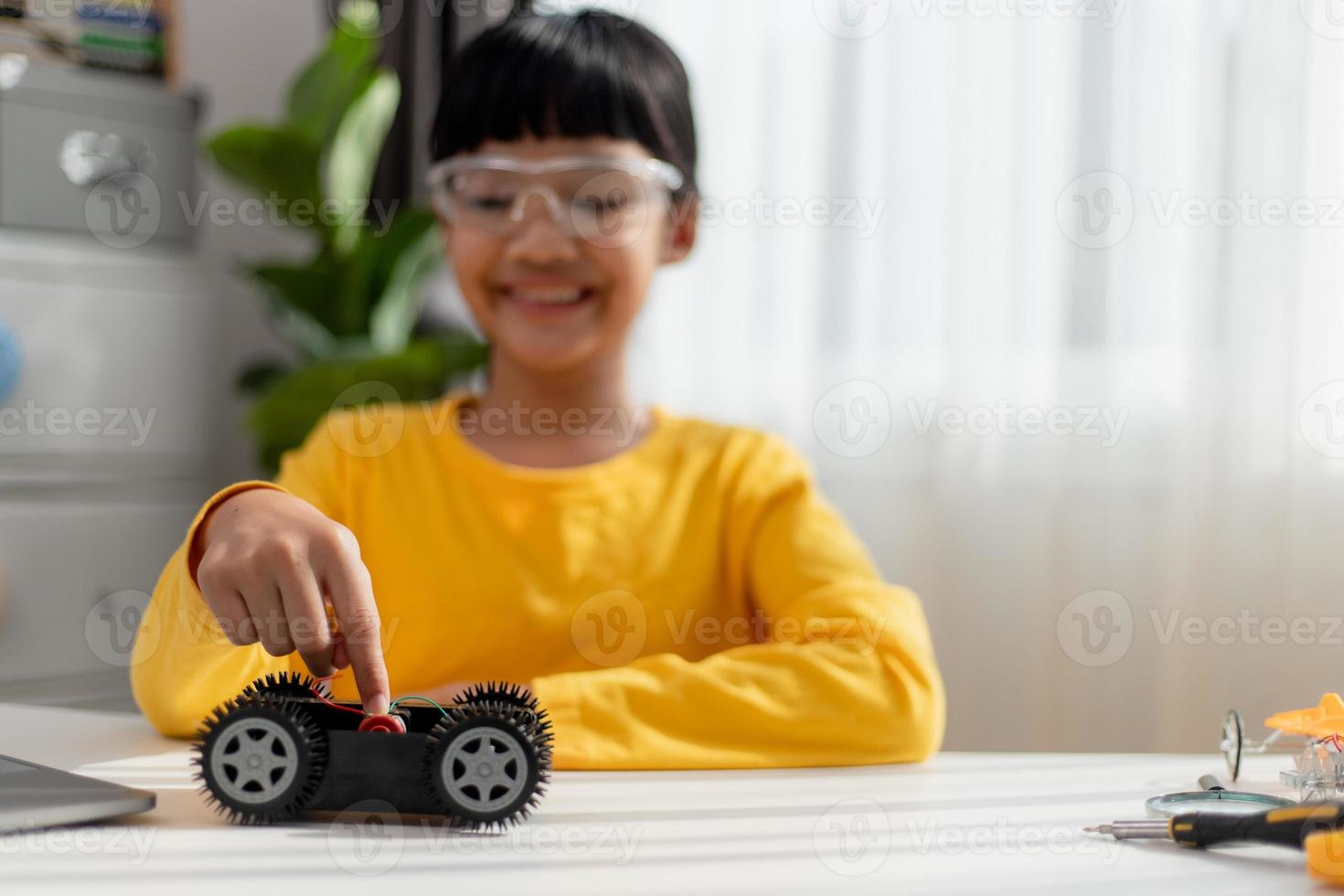 Asia students learn at home in coding robot cars and electronic board cables in STEM, STEAM, mathematics engineering science technology computer code in robotics for kids concept. photo