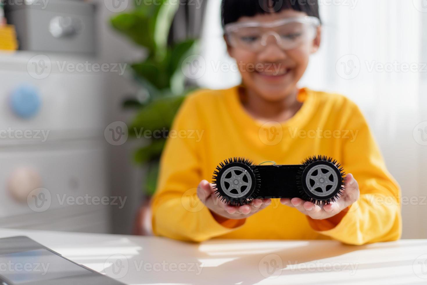 Asia students learn at home in coding robot cars and electronic board cables in STEM, STEAM, mathematics engineering science technology computer code in robotics for kids concept. photo