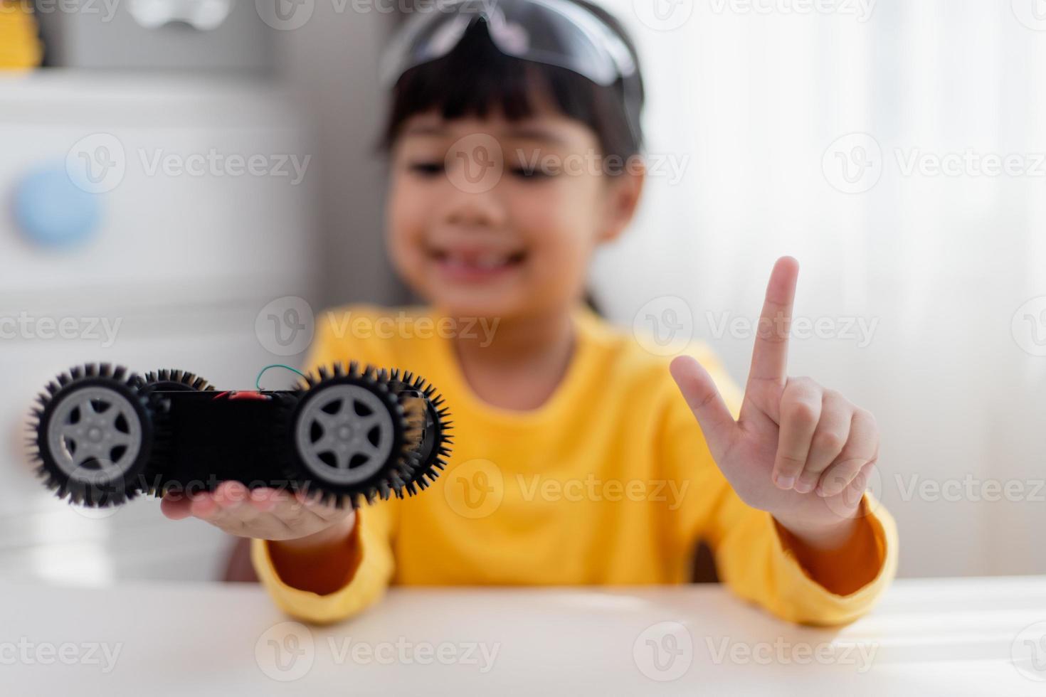 Asia students learn at home in coding robot cars and electronic board cables in STEM, STEAM, mathematics engineering science technology computer code in robotics for kids concept. photo