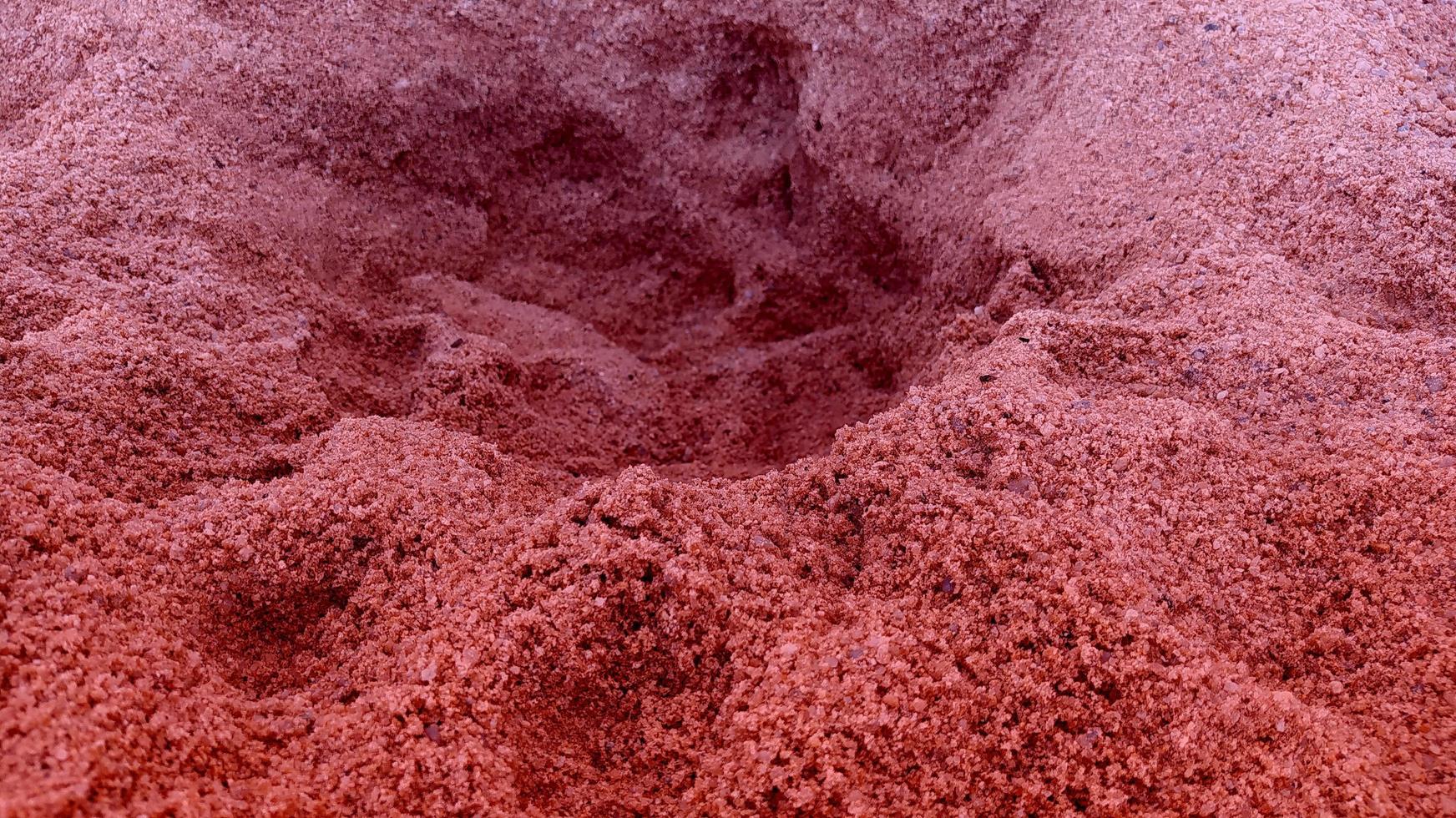 Background of the red color of the texture and pattern of the sand floor. photo