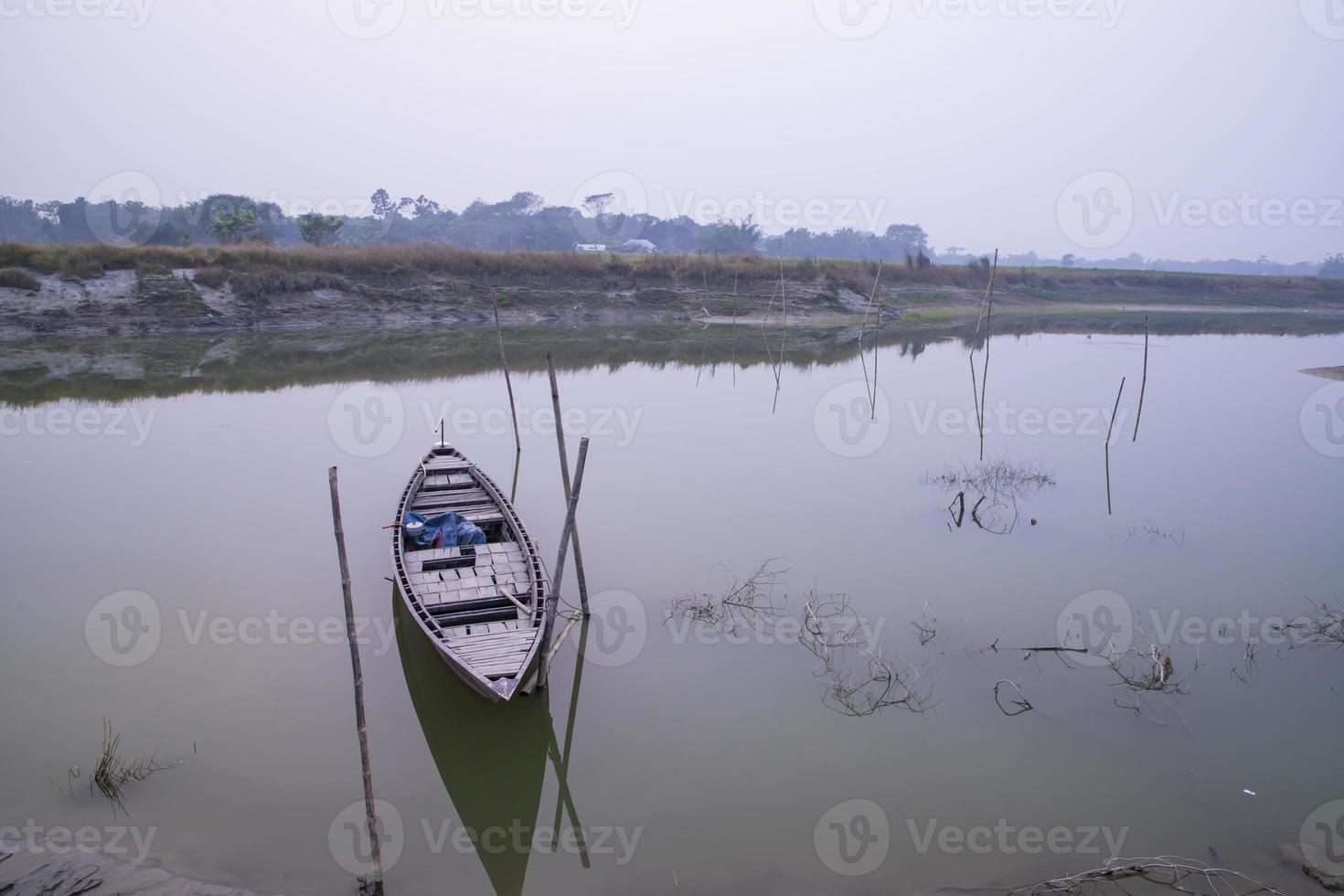 Landscape View of wooden fishing boats on the bank of the lake photo