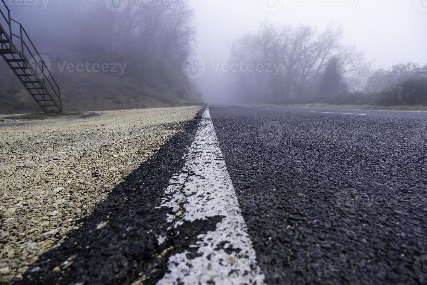 Mountain road with fog photo