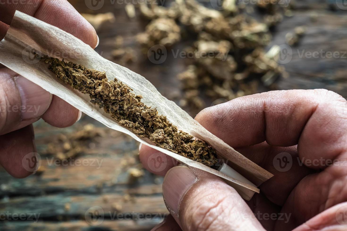 cannabis smoker rolling marijuana cannabis joint. Drugs narcotic concept. photo