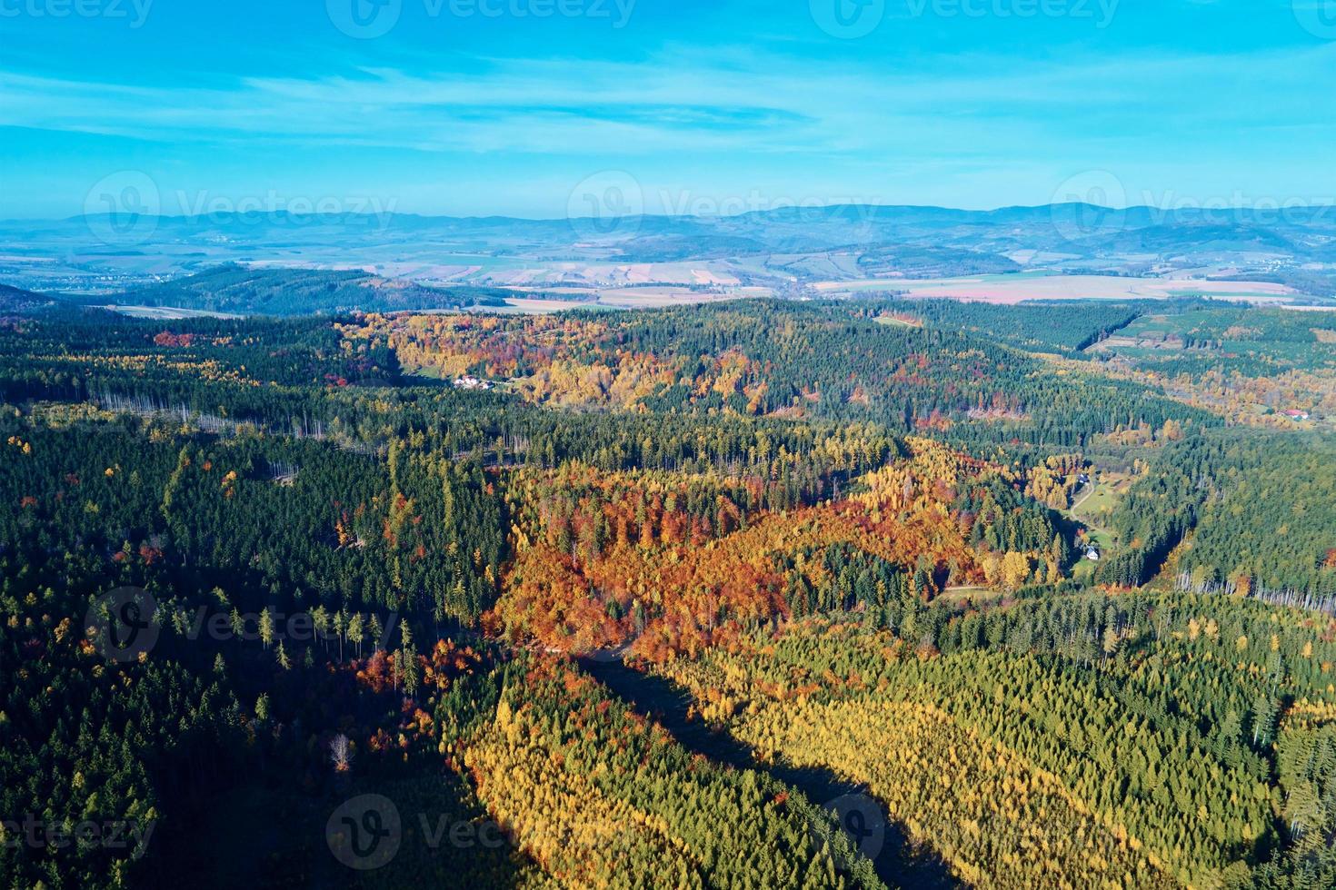 Aerial view of mountains covered with autumn forest photo