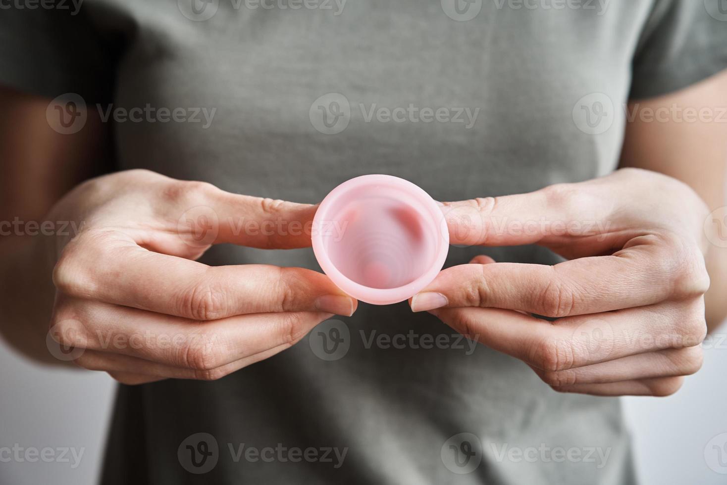 Woman holds menstrual cup in hands photo