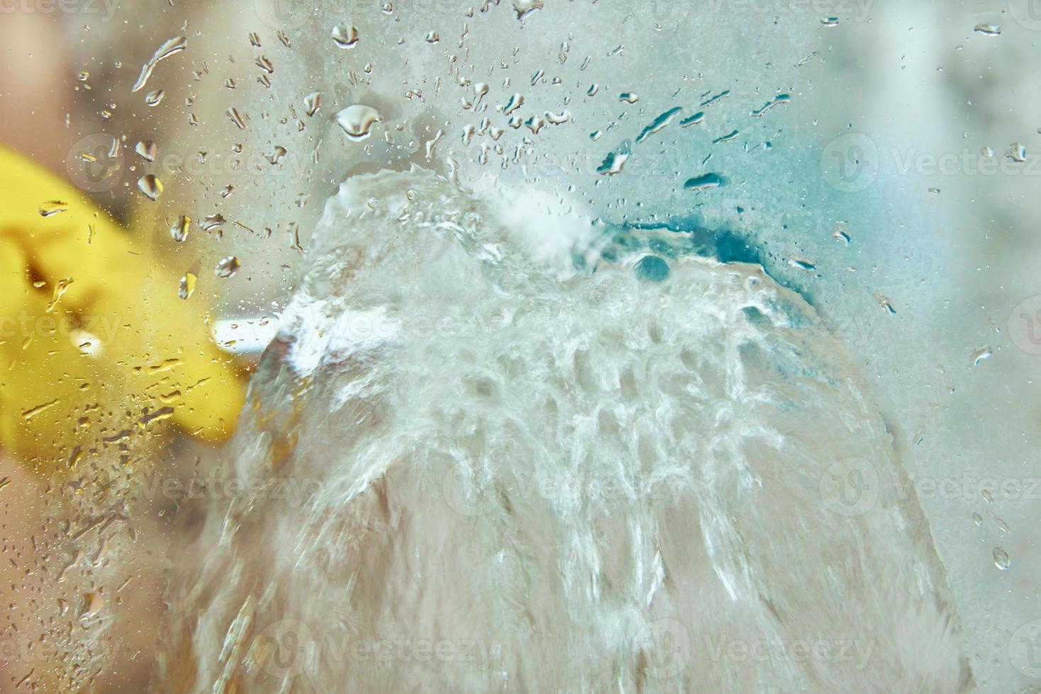 Woman cleaning bathroom cabine photo