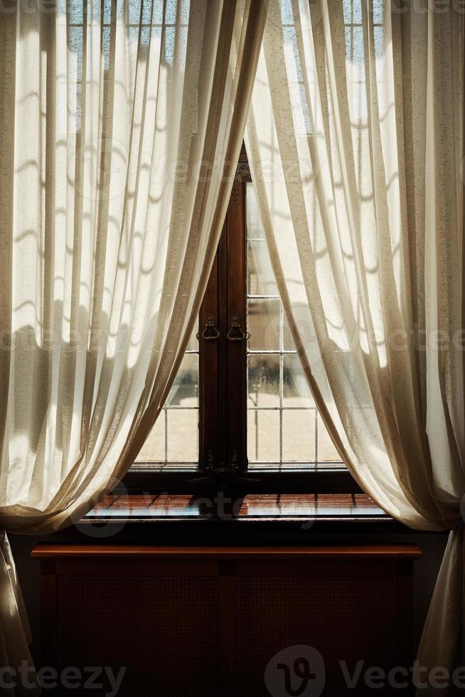 Vintage window with curtains photo