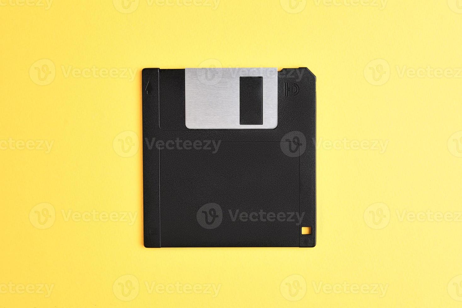 Floppy disk on yellow background photo