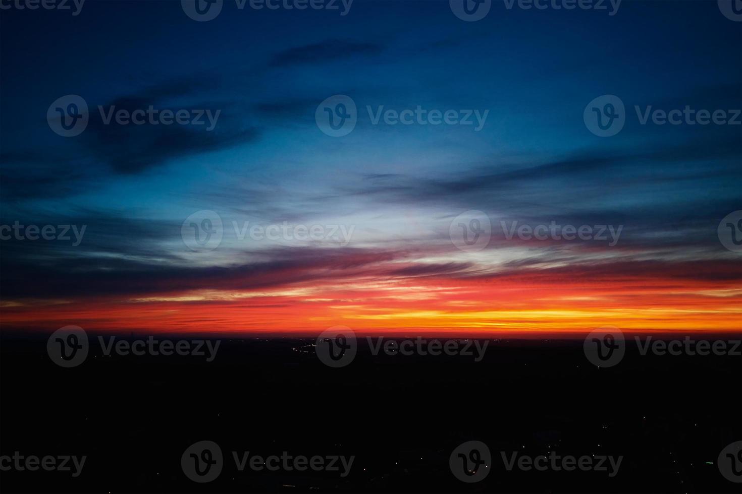 Beautiful sunrise cloudy sky over small city photo