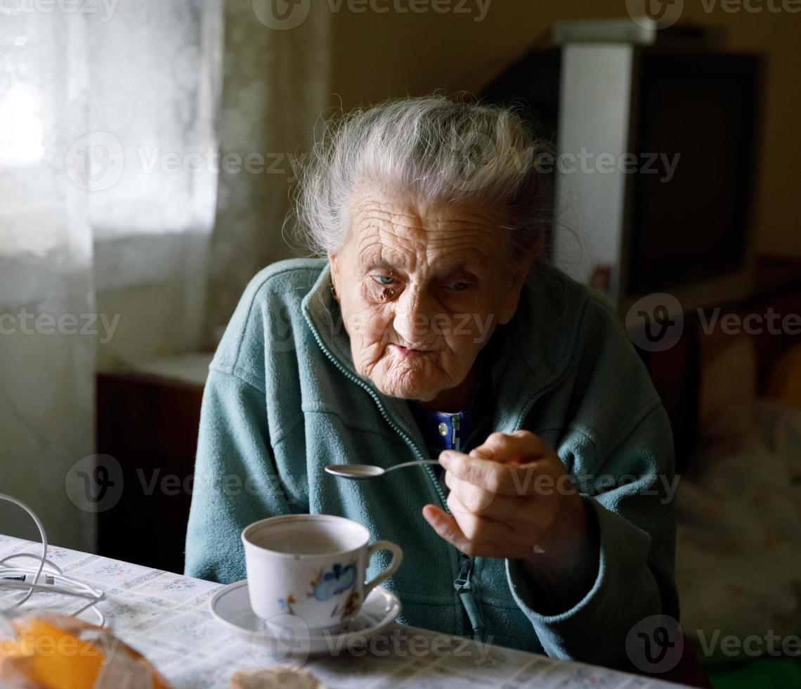 Elderly lonely woman photo